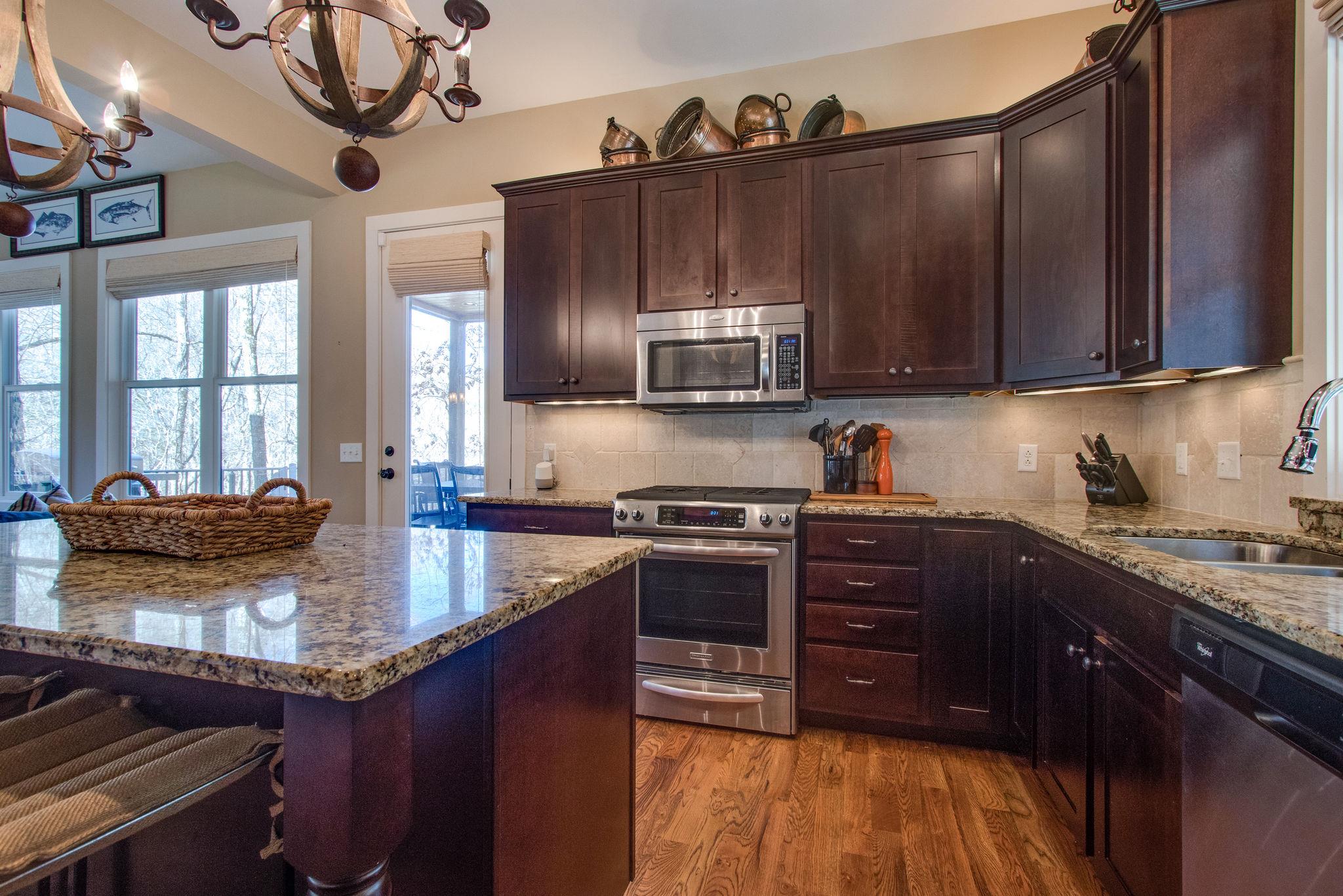 750 Floating Mill Village Road Silver Point, TN 38582 - Photo 10 of 30 a kitchen with stainless steel appliances granite countertop a stove a sink and a microwave