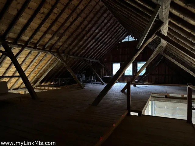 a kitchen with stainless steel appliances granite countertop a refrigerator a stove and a dining table with wooden floor