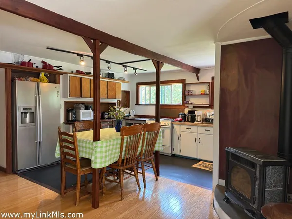 a bedroom with a bed a table and a large mirror