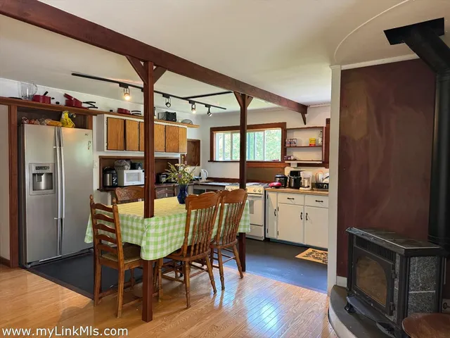 a bedroom with a bed a table and a large mirror