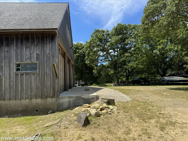 a backyard of a house with yard and outdoor seating