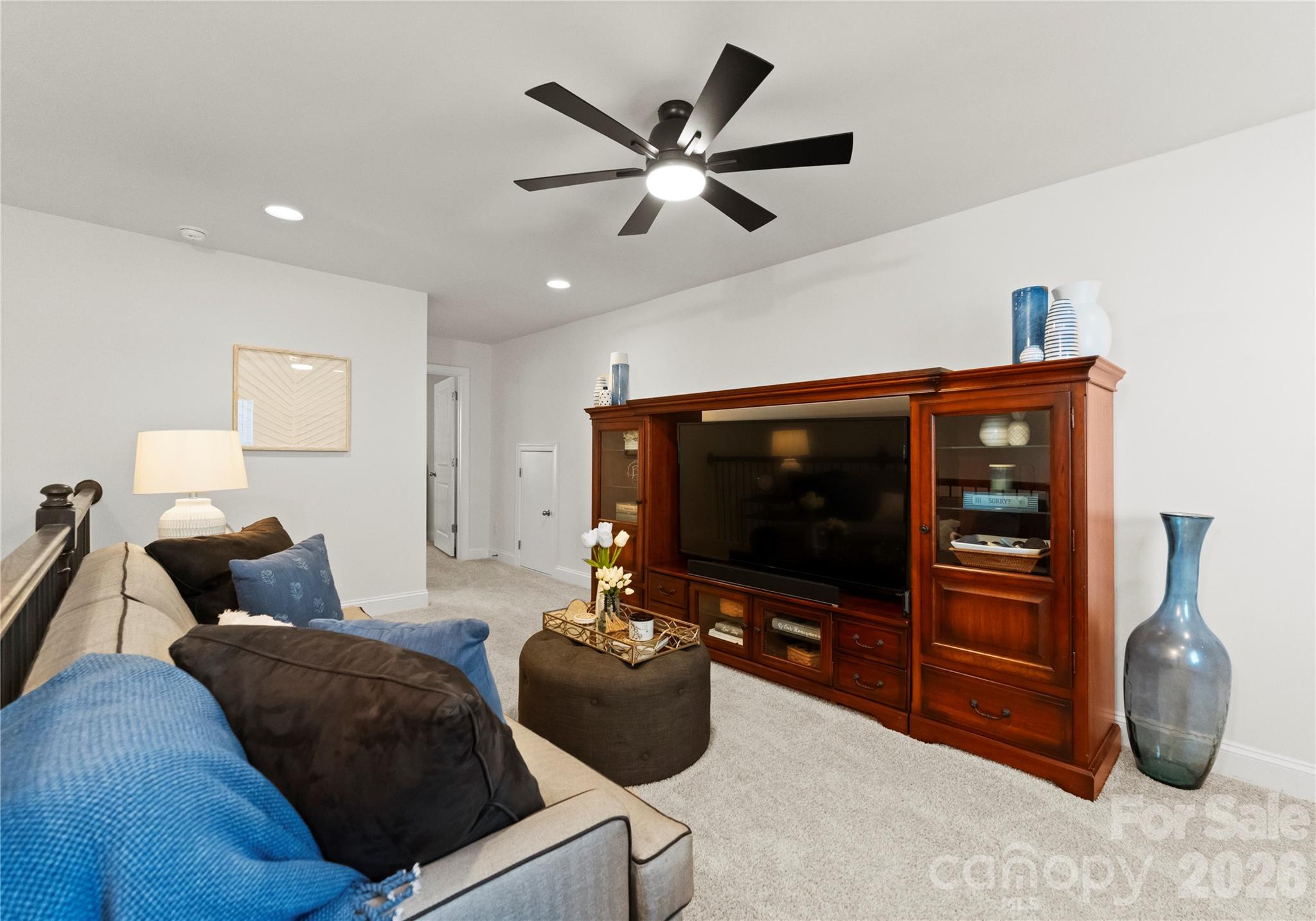 349 Preston Road Mooresville, NC 28117 - Photo 28 of 48 a living room with furniture a ceiling fan and a window