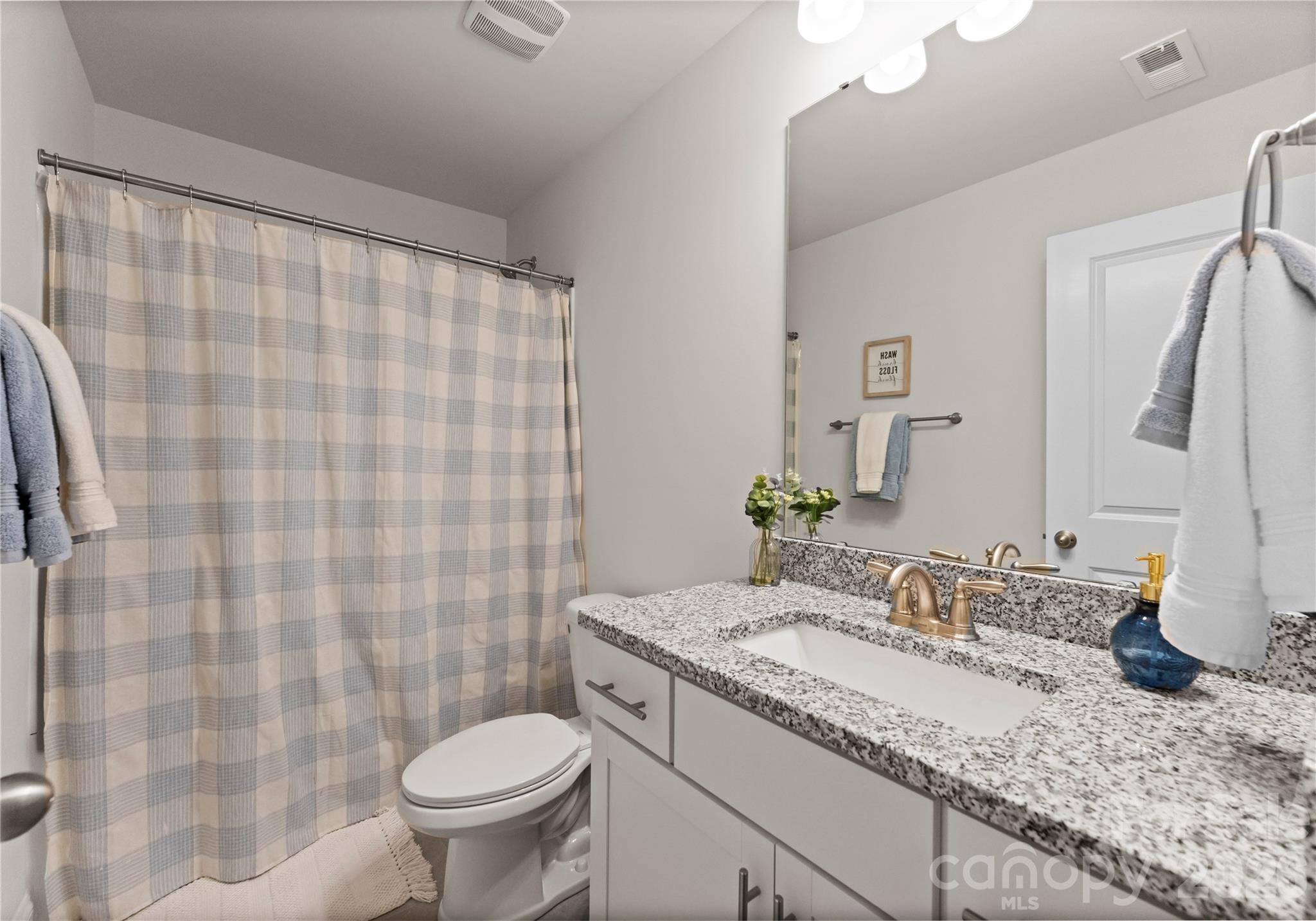 349 Preston Road Mooresville, NC 28117 - Photo 31 of 48 a bathroom with a granite countertop sink toilet and a mirror