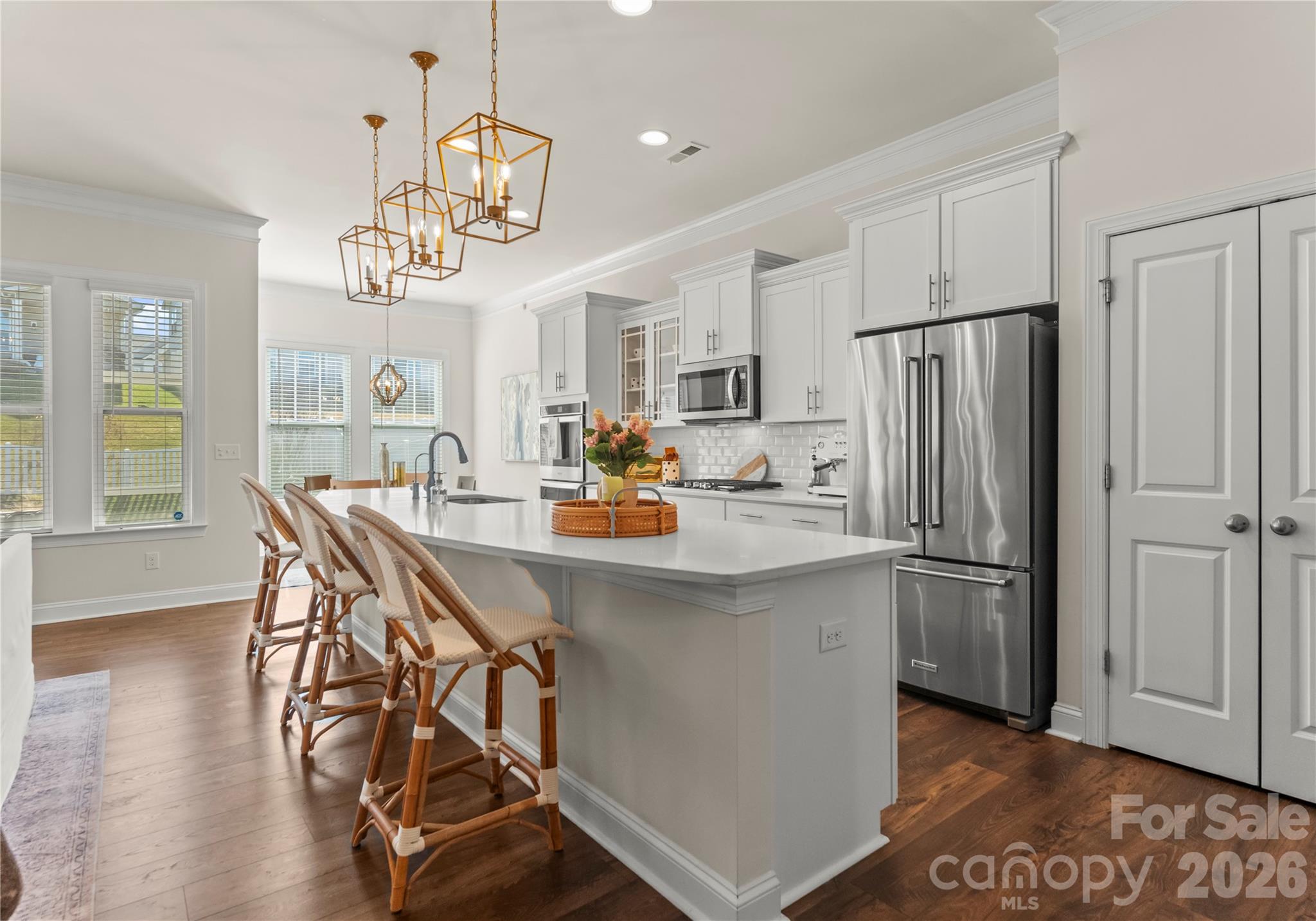 349 Preston Road Mooresville, NC 28117 - Photo 9 of 48 a kitchen with stainless steel appliances a dining table chairs refrigerator and microwave