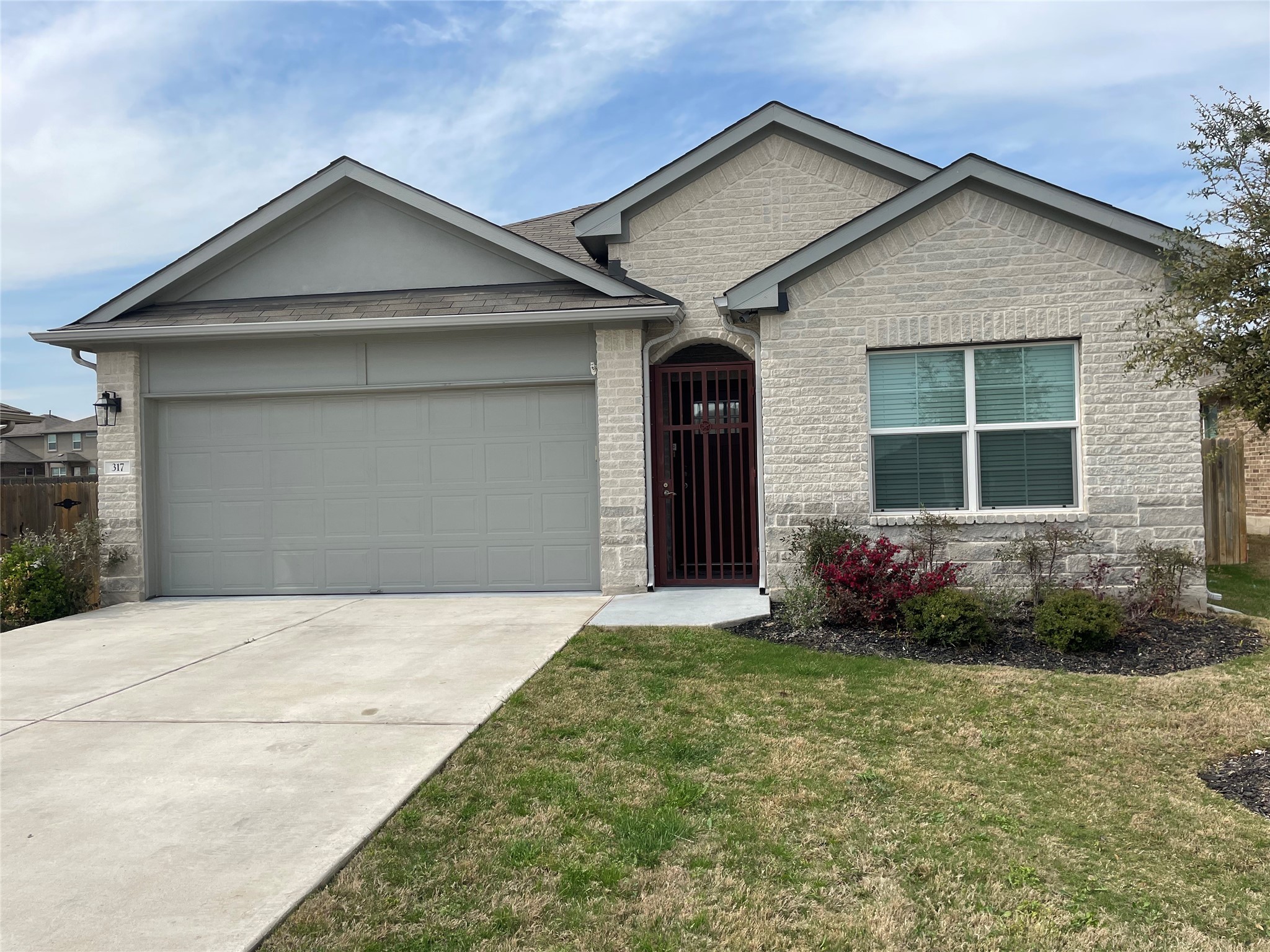 a front view of a house with garden