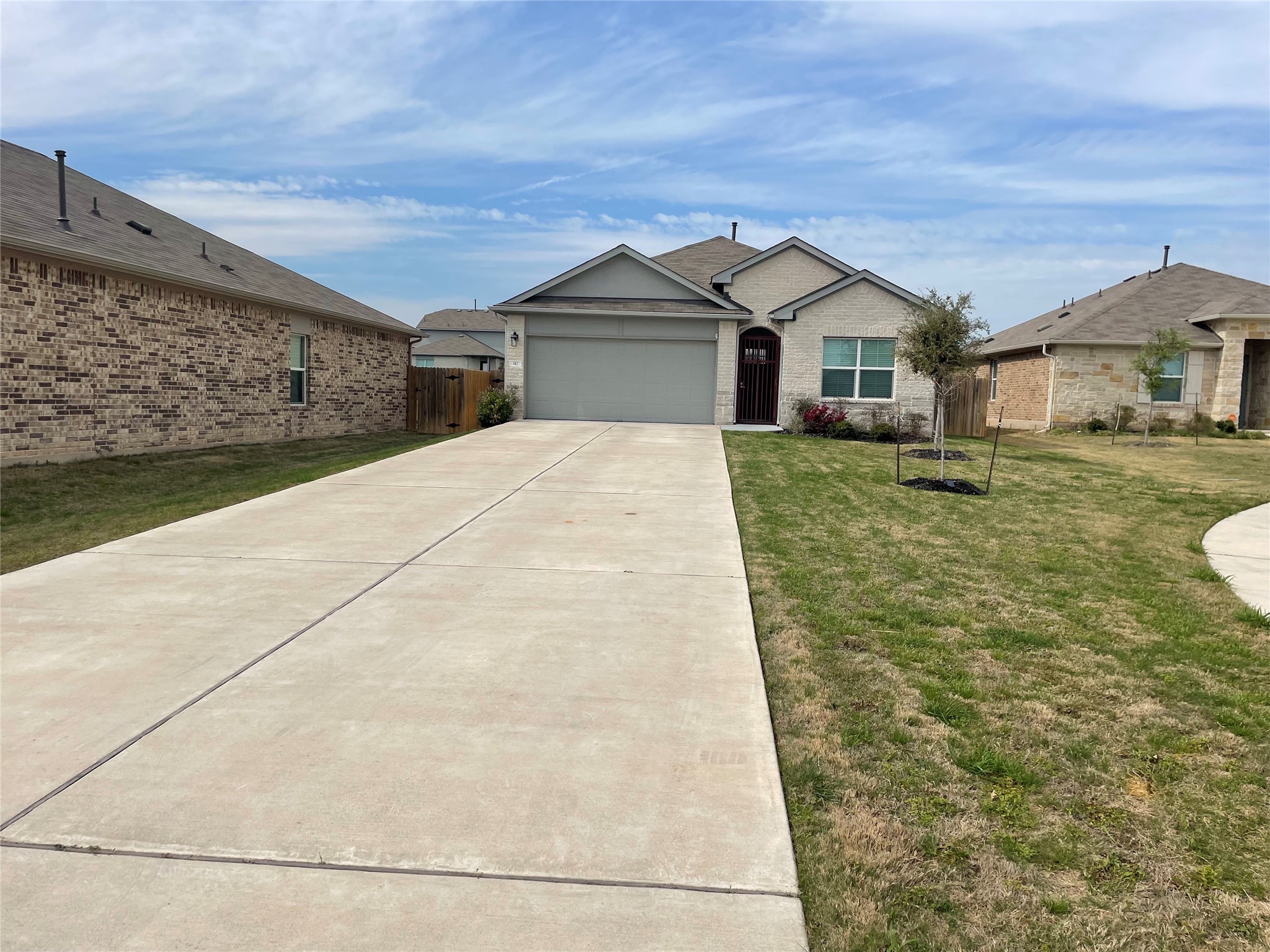 317 Bremen Street Georgetown, TX 78626 - Photo 2 of 19 a front view of a house with a yard and garage