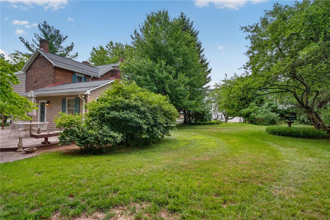765 East Macada Road Bethlehem, PA 18017 - Photo 43 of 46 A verdant backyard with mature trees and a comfortable outdoor deck for relaxation.