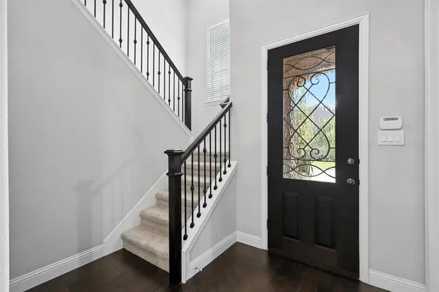 a view of staircase with wooden floor and a window