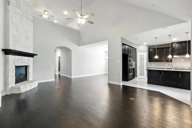 an open kitchen with a sink and a stove top oven