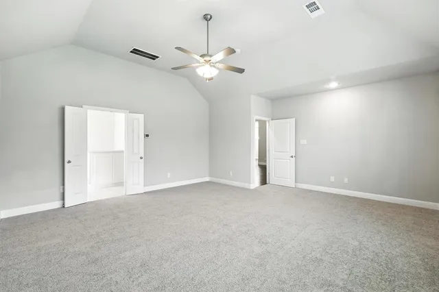 a view of an empty room with a ceiling fan