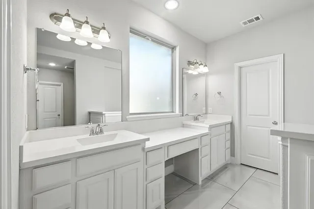 a bathroom with a sink vanity and a mirror