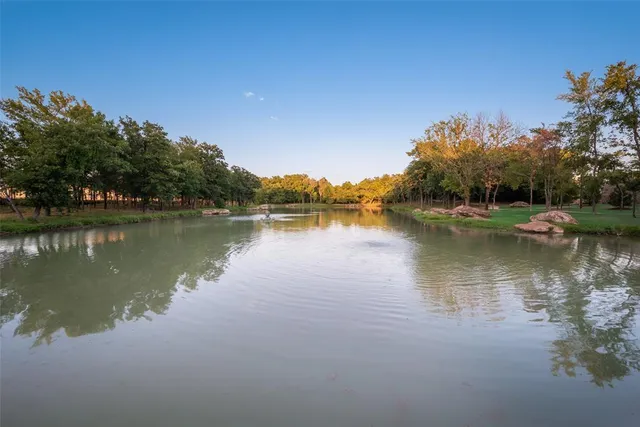 a view of a lake with houses in the background