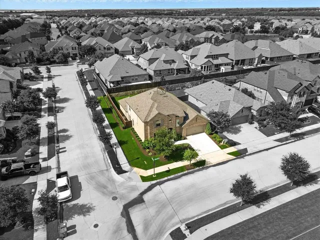 an aerial view of a residential houses with outdoor space