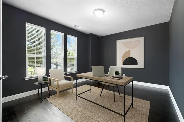 a work room with furniture and a window