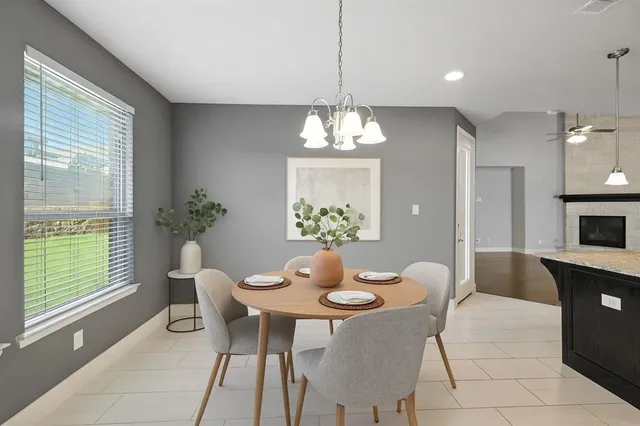 a dining room with furniture a chandelier and wooden floor