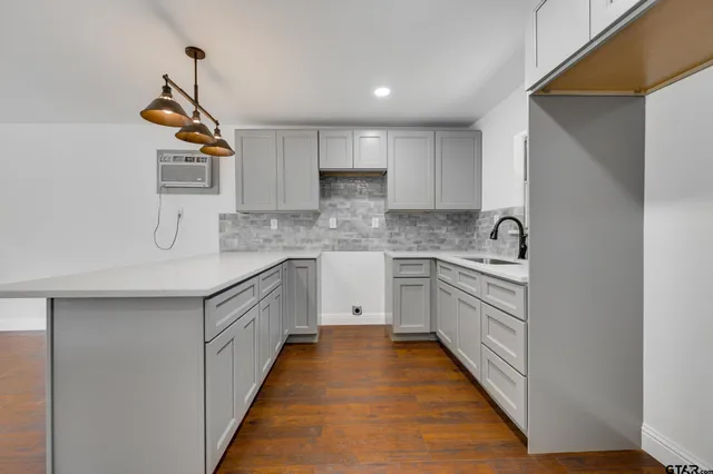 a kitchen with a sink dishwasher a stove and a refrigerator