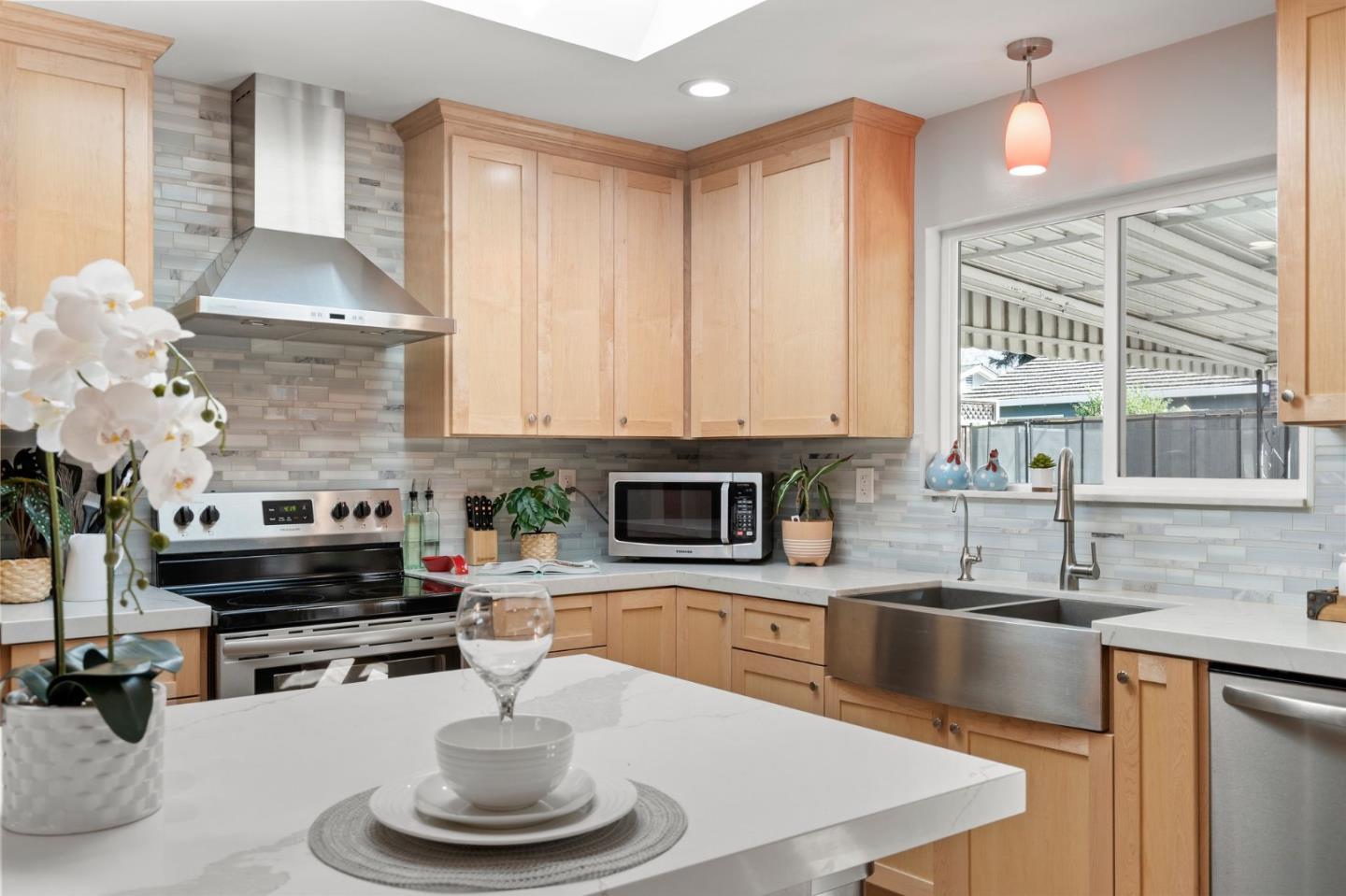 5074 Williams Road San Jose, CA 95129 - Photo 12 of 35 a kitchen with a stove a sink and a white cabinets