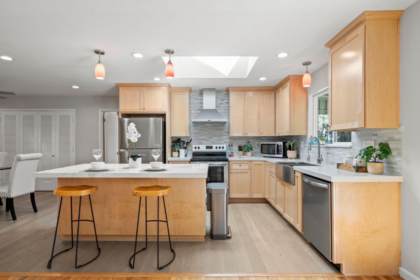 5074 Williams Road San Jose, CA 95129 - Photo 13 of 35 a kitchen with kitchen island granite countertop wooden cabinets and white appliances