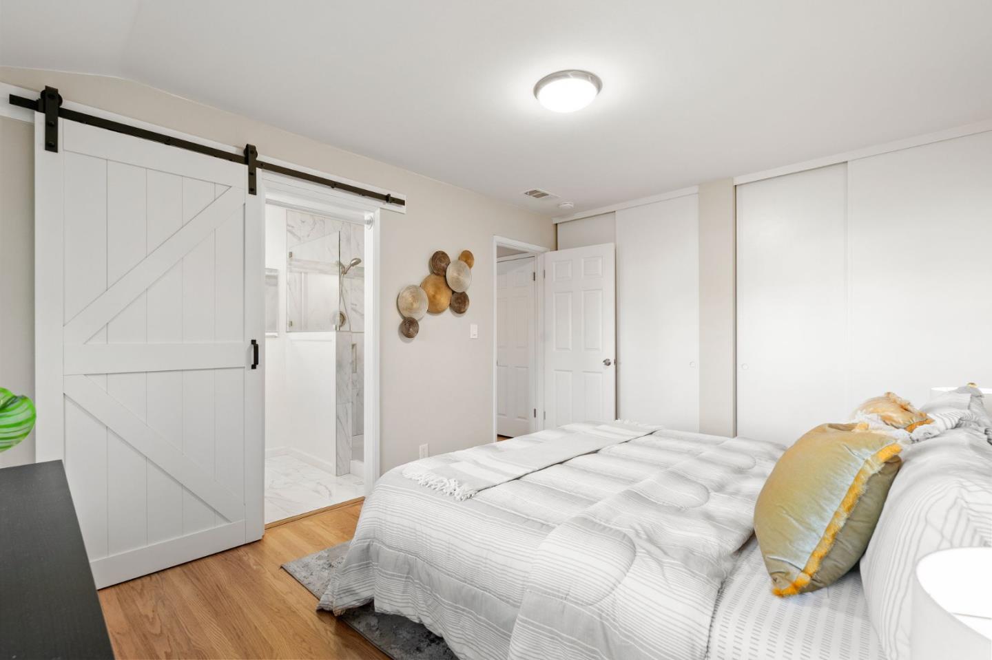 5074 Williams Road San Jose, CA 95129 - Photo 17 of 35 a bedroom with a bed and wooden floor