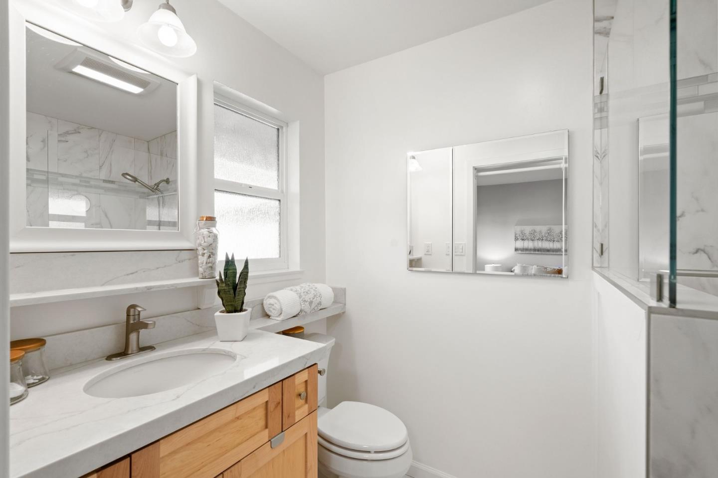 5074 Williams Road San Jose, CA 95129 - Photo 21 of 35 a bathroom with a sink vanity granite toilet and a mirror