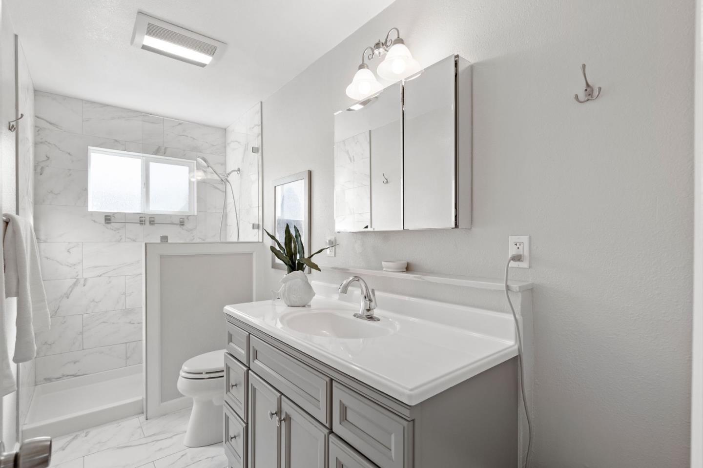 5074 Williams Road San Jose, CA 95129 - Photo 22 of 35 a bathroom with a sink toilet and shower