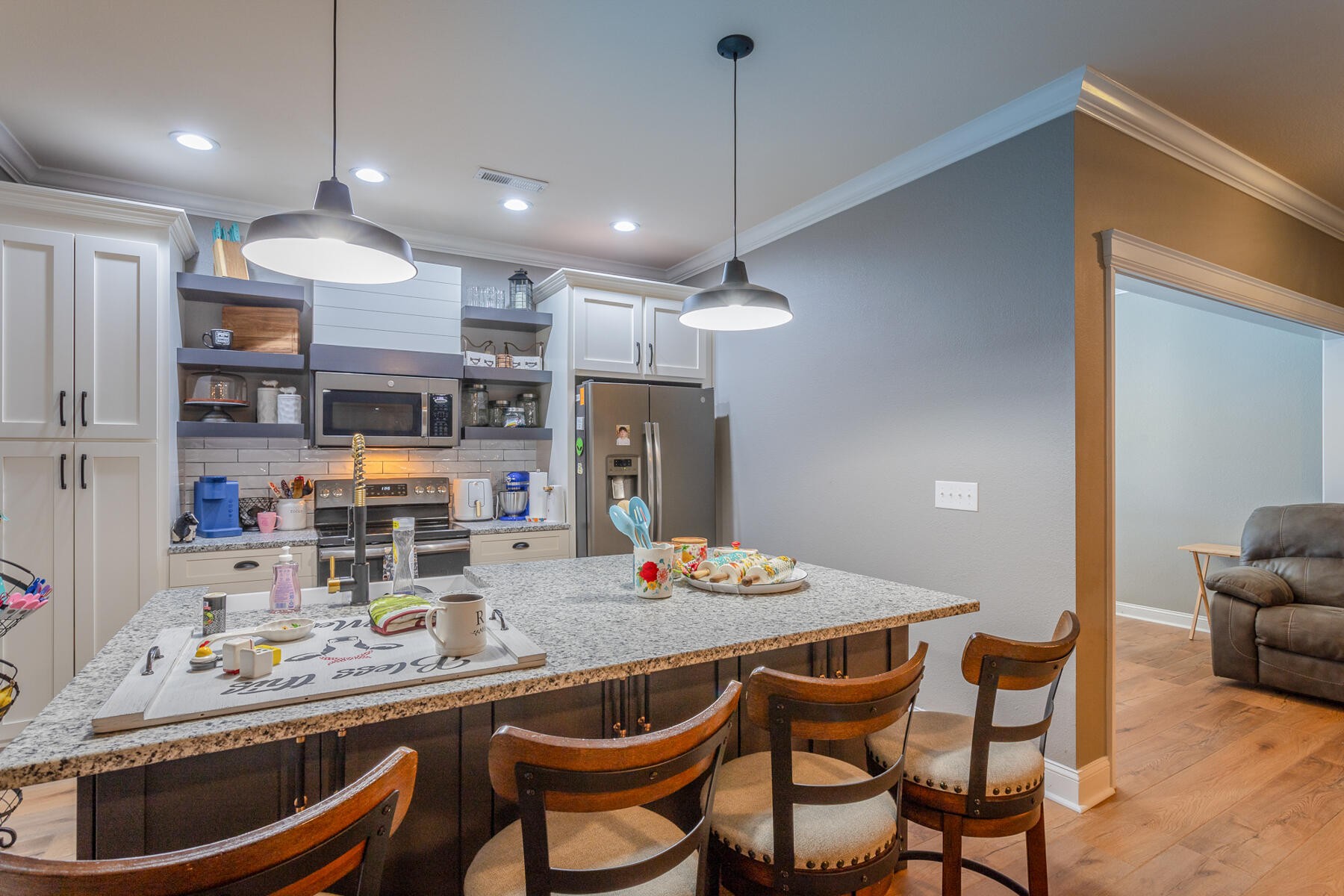 875 Colony Circle Fort Oglethorpe, GA 30742 - Photo 12 of 42 a kitchen with stainless steel appliances granite countertop a sink a stove a refrigerator and chairs