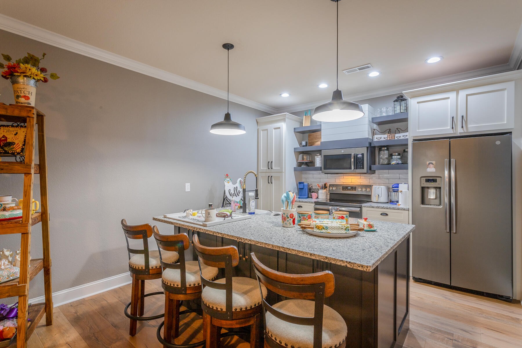 875 Colony Circle Fort Oglethorpe, GA 30742 - Photo 13 of 42 a kitchen with kitchen island a dining table and chairs