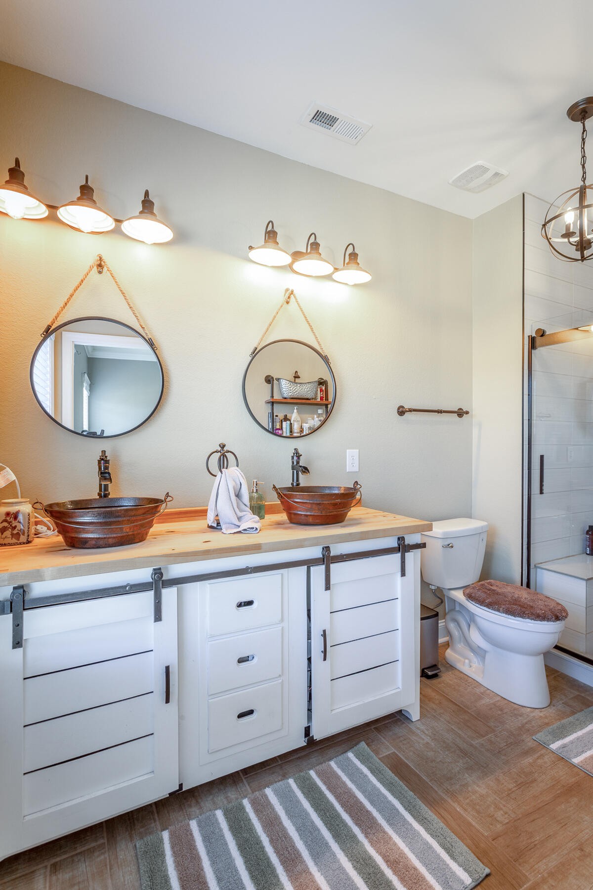 875 Colony Circle Fort Oglethorpe, GA 30742 - Photo 24 of 42 a bathroom with a toilet a sink and mirror