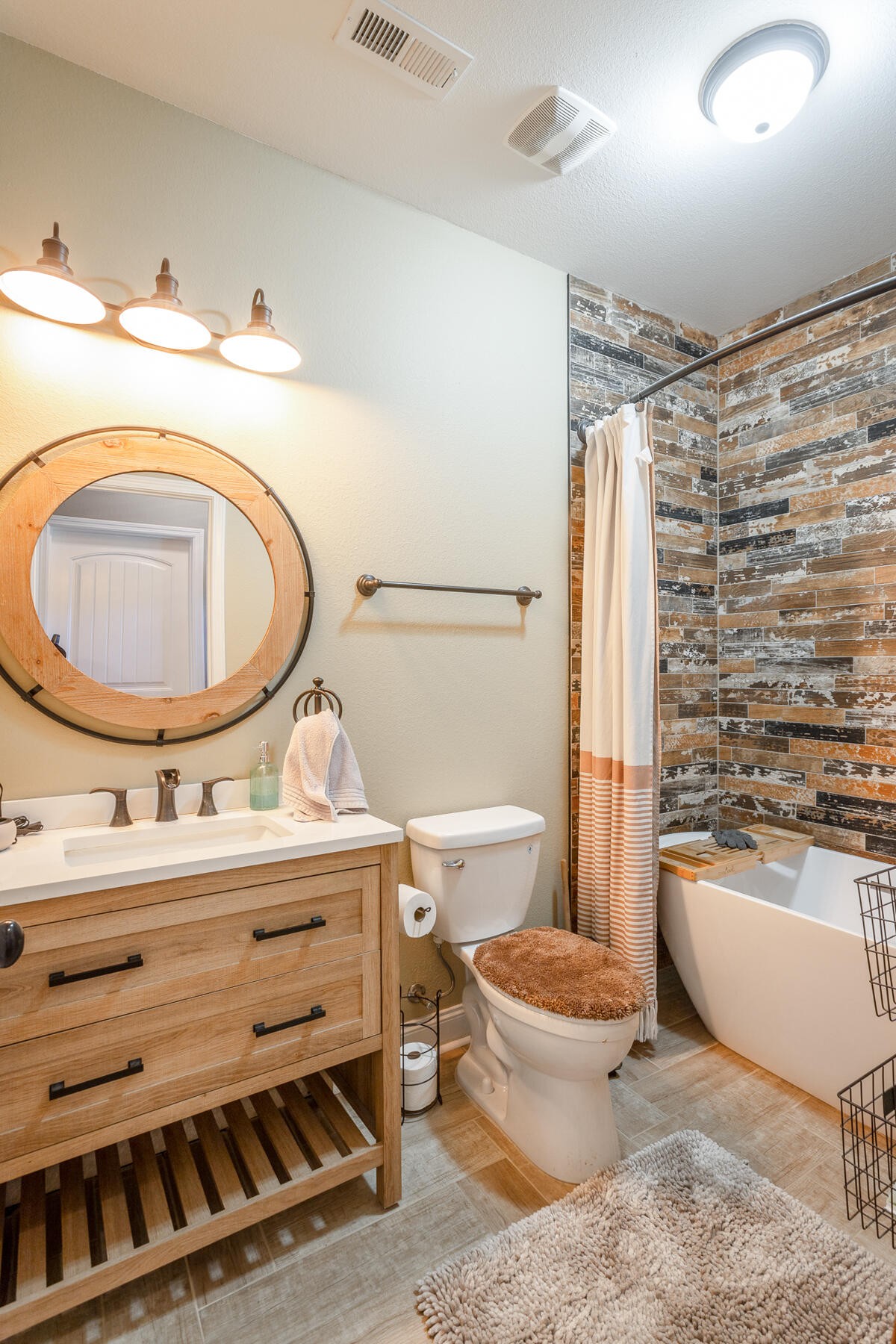 875 Colony Circle Fort Oglethorpe, GA 30742 - Photo 28 of 42 a bathroom with a sink a toilet and a mirror