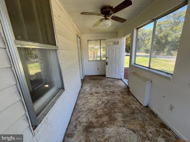 a view of hallway with window and stairs