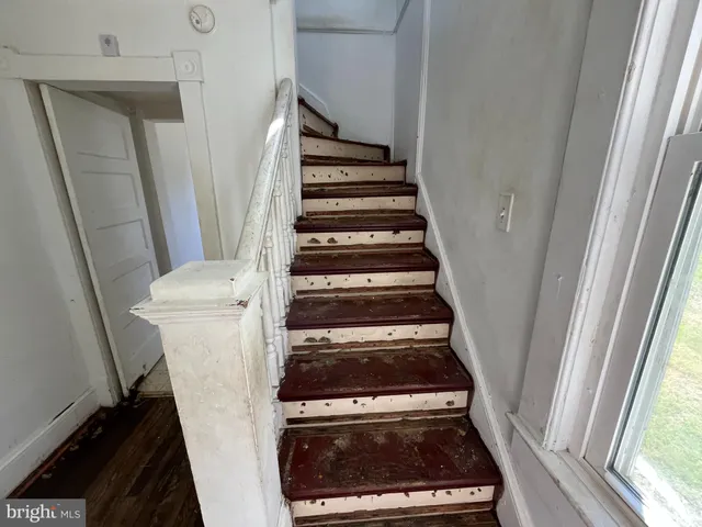 a view of entryway and utility room with stairs