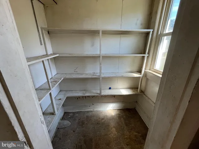 a view of storage and utility room with racks on the wall
