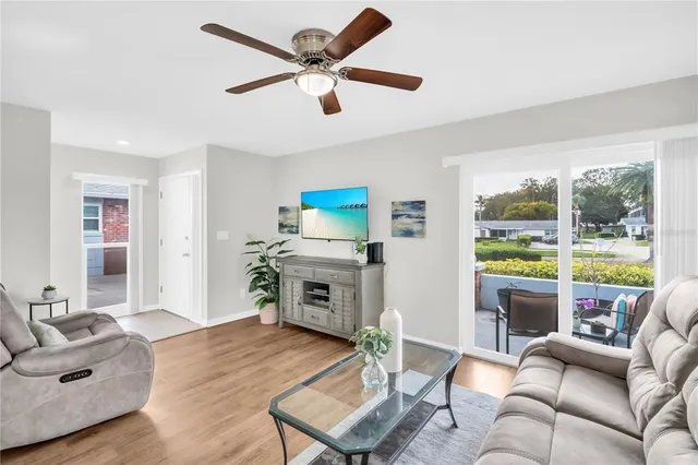 a living room with furniture flat screen tv and a fireplace