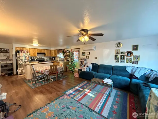 a living room with furniture and kitchen view