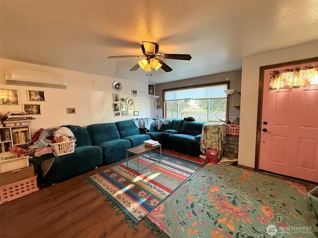a living room with furniture ceiling fan and a rug