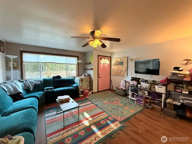 a living room with furniture and a flat screen tv