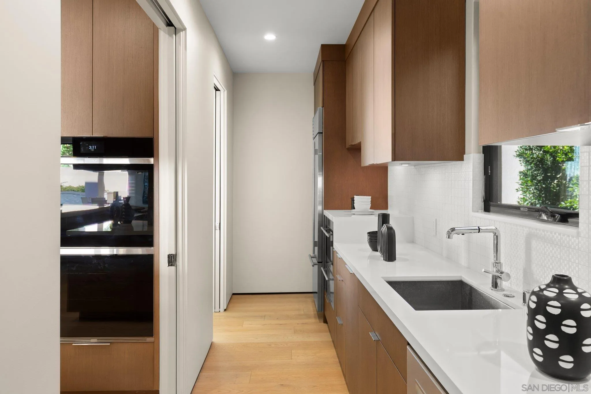 6349 Castejon Drive La Jolla, CA 92037 - Photo 15 of 43 a kitchen with a sink and a refrigerator