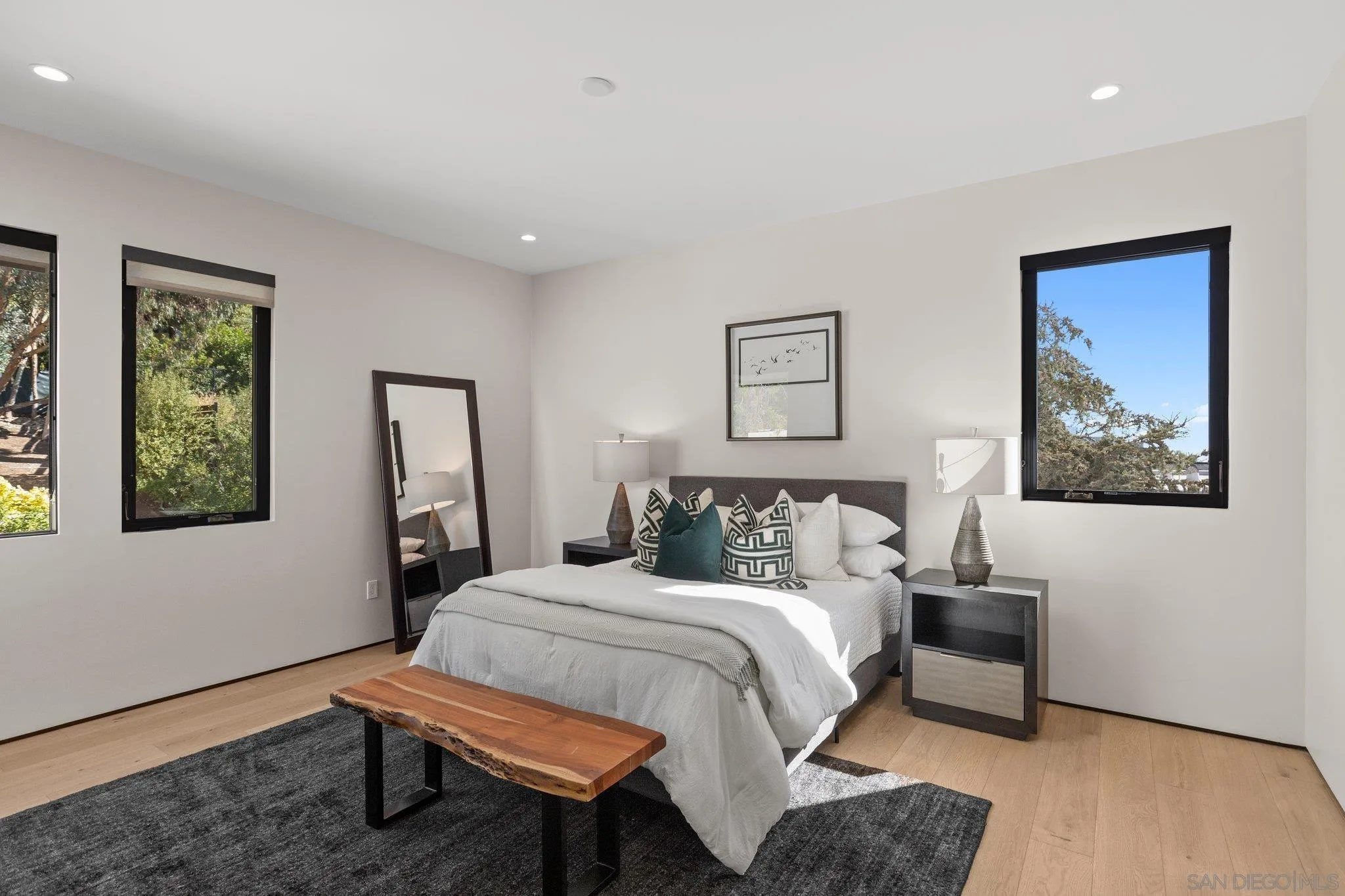 6349 Castejon Drive La Jolla, CA 92037 - Photo 34 of 43 a bedroom with a bed a painting and a lamp