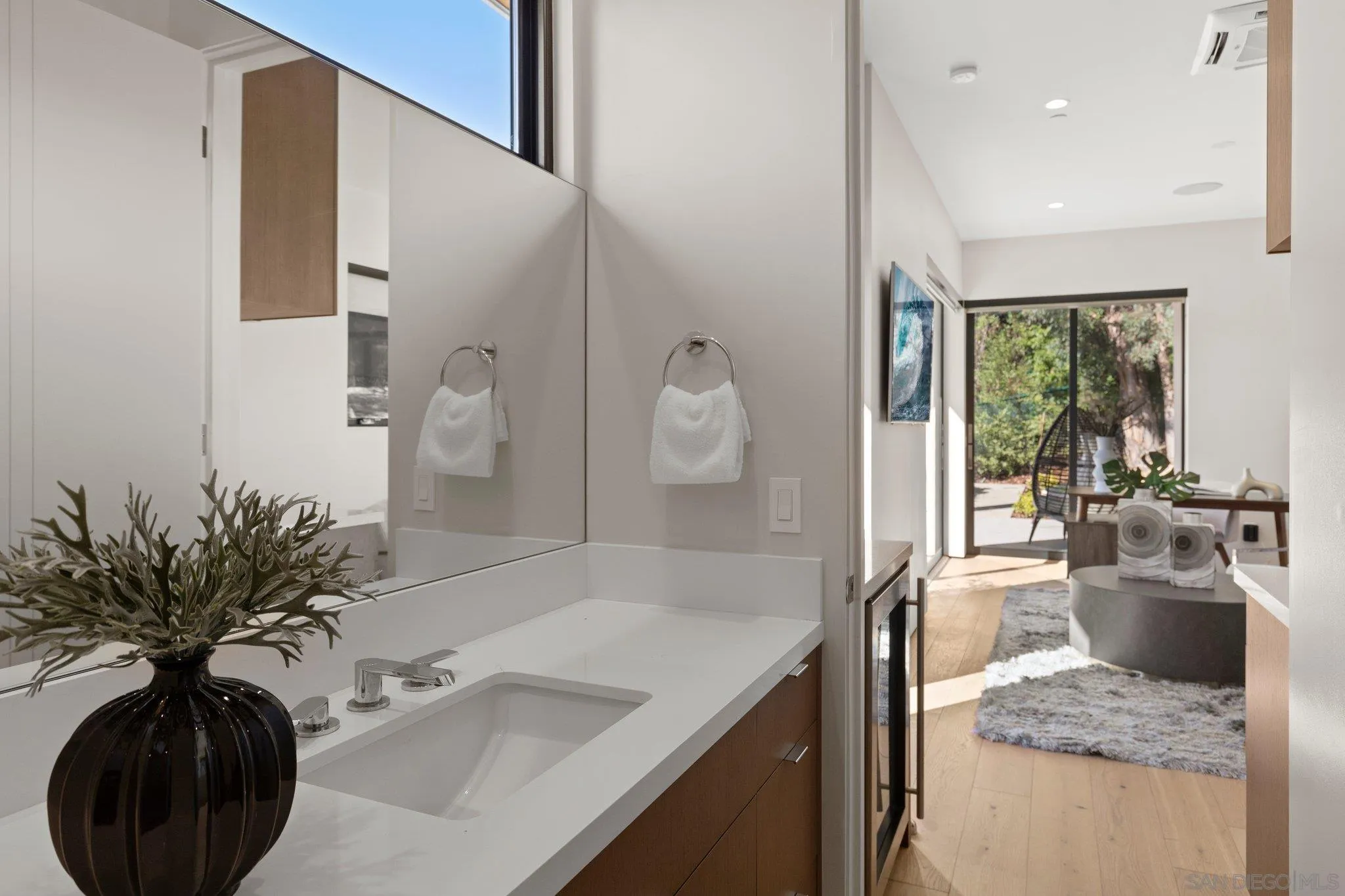 6349 Castejon Drive La Jolla, CA 92037 - Photo 40 of 43 a bathroom with a granite countertop sink a large mirror and a shower