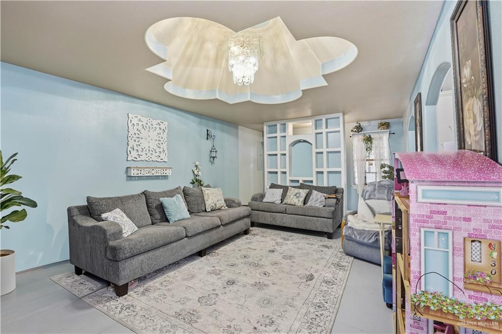 121 Jo Beth Street Alton, TX 78573 - Photo 2 of 12 a living room with furniture and a chandelier