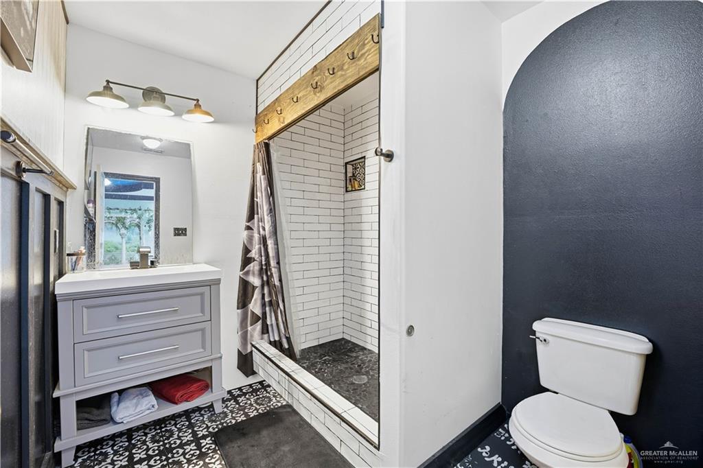 121 Jo Beth Street Alton, TX 78573 - Photo 9 of 12 a bathroom with a toilet and a shower