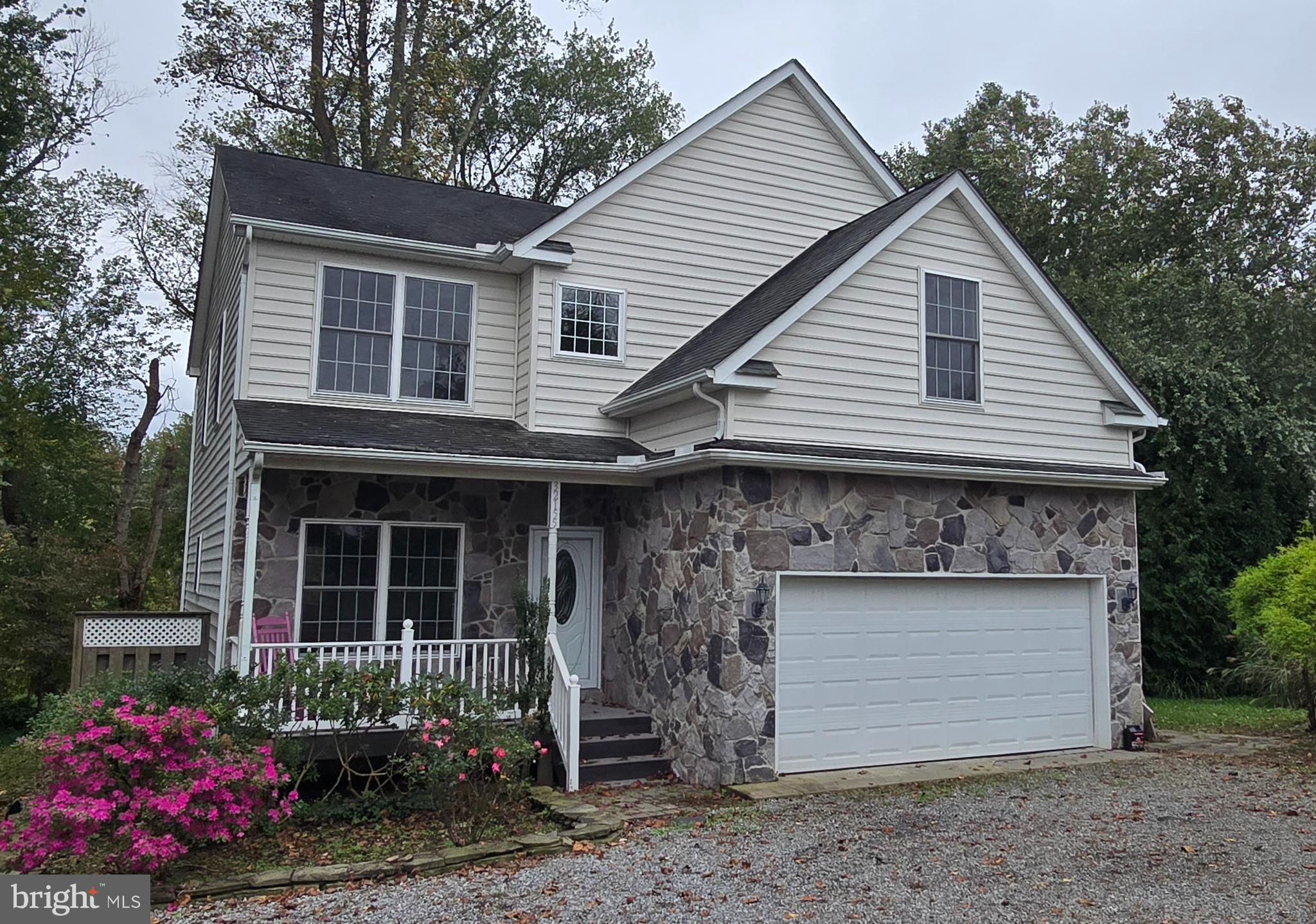 32155 River Road Millington, MD 21651 - Photo 1 of 54 a front view of a house with a garden