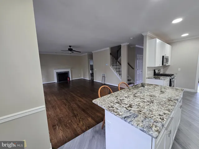 a view of kitchen island sink microwave and refrigerator