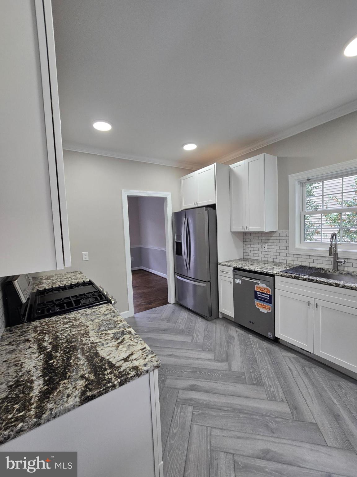 32155 River Road Millington, MD 21651 - Photo 16 of 54 a kitchen with stainless steel appliances granite countertop a sink stove and refrigerator