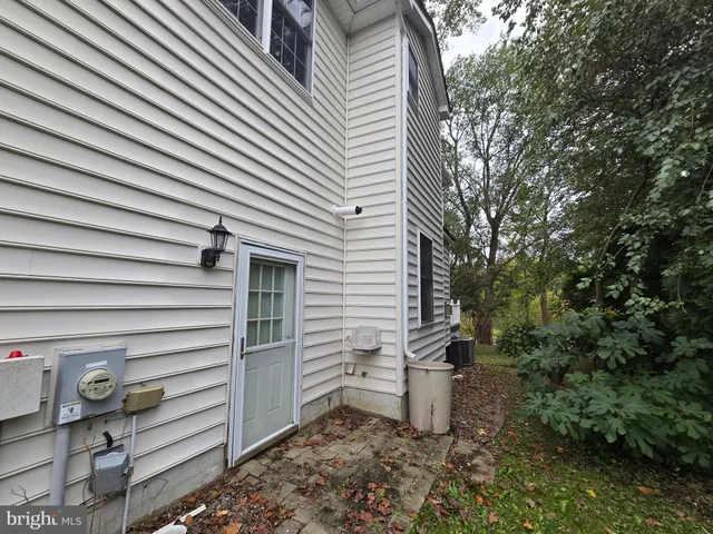 a view of a house with a yard and large trees