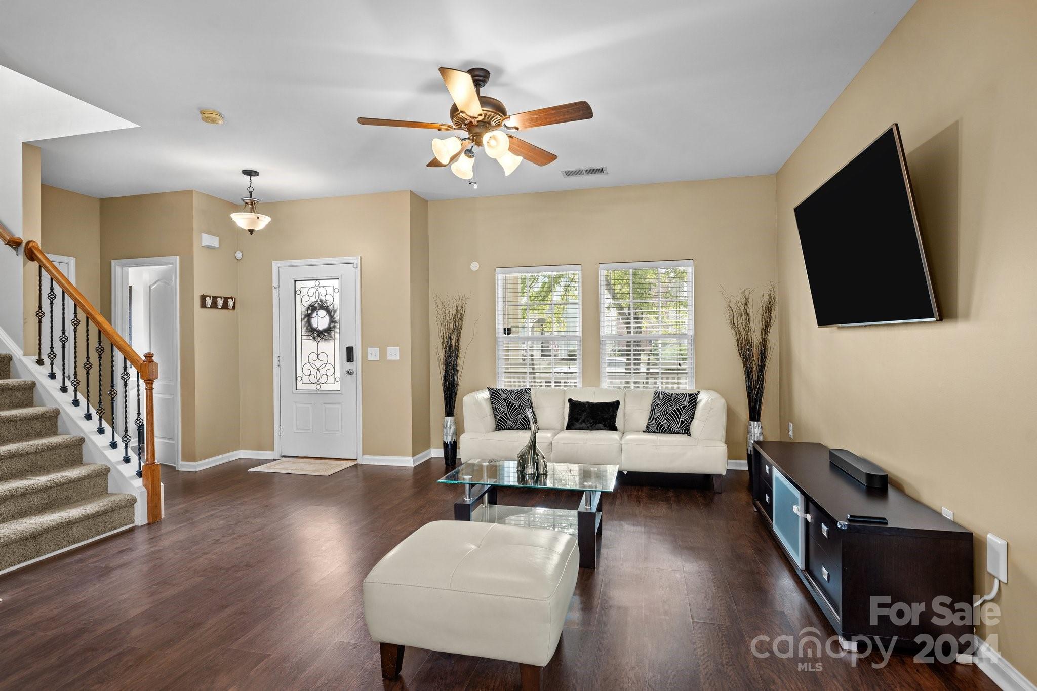 10231 Enniscrone Road Pineville, NC 28134 - Photo 11 of 44 a living room with furniture and a flat screen tv