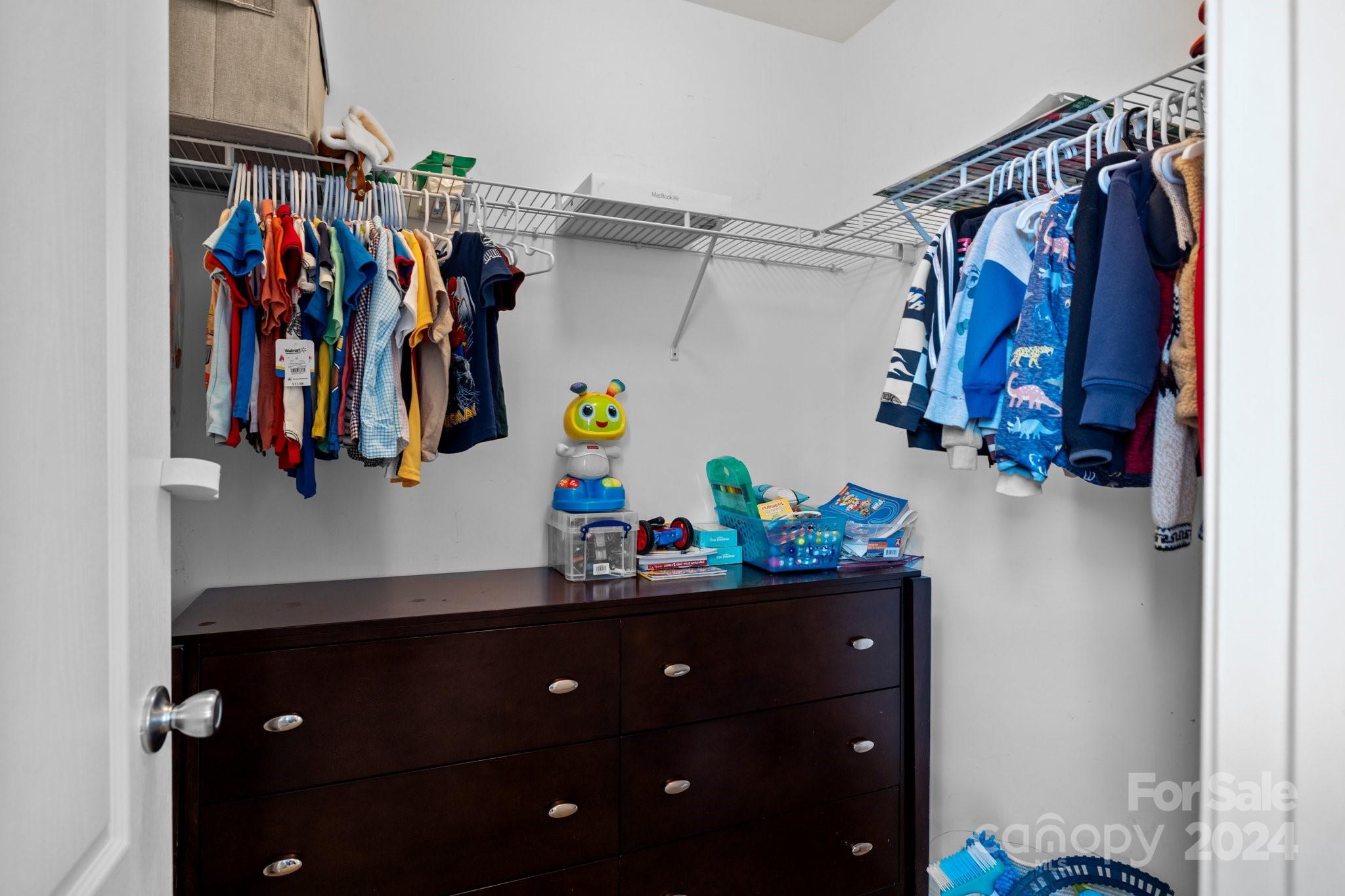 10231 Enniscrone Road Pineville, NC 28134 - Photo 25 of 44 a view of walk in closet with clothes