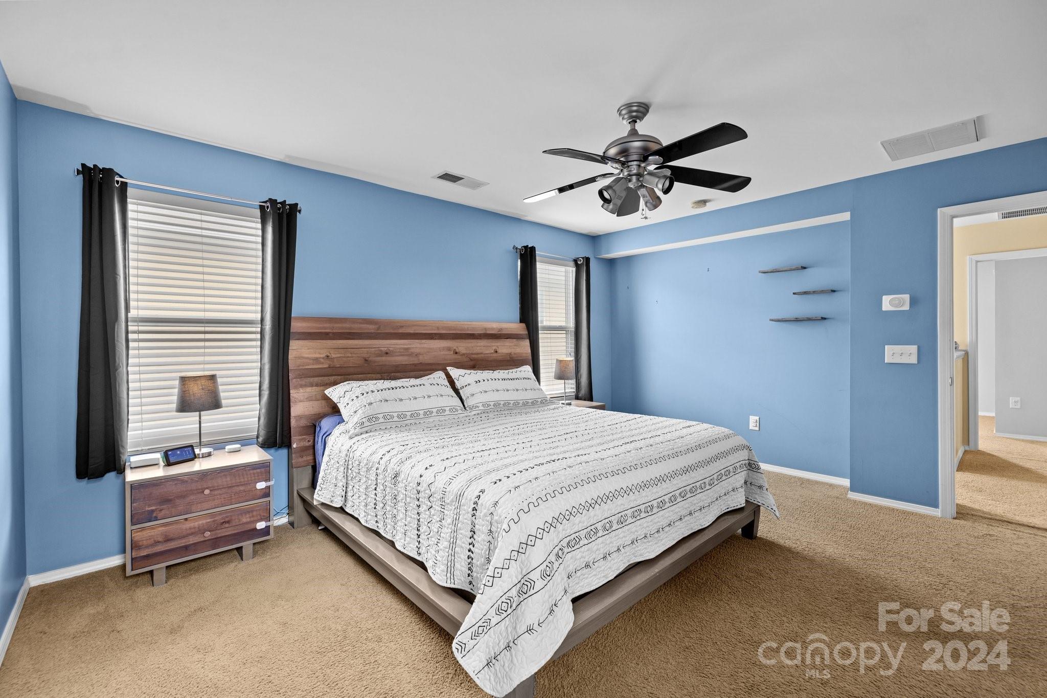 10231 Enniscrone Road Pineville, NC 28134 - Photo 27 of 44 a bedroom with a bed chandelier and a window