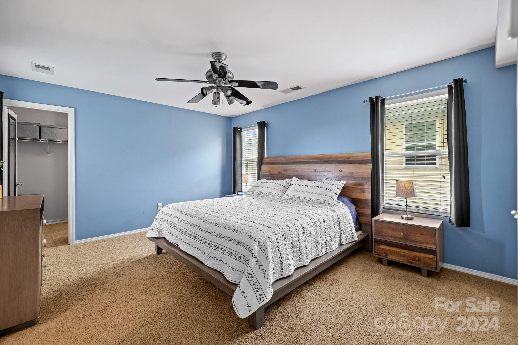 10231 Enniscrone Road Pineville, NC 28134 - Photo 29 of 44 a bedroom with a bed and a chandelier