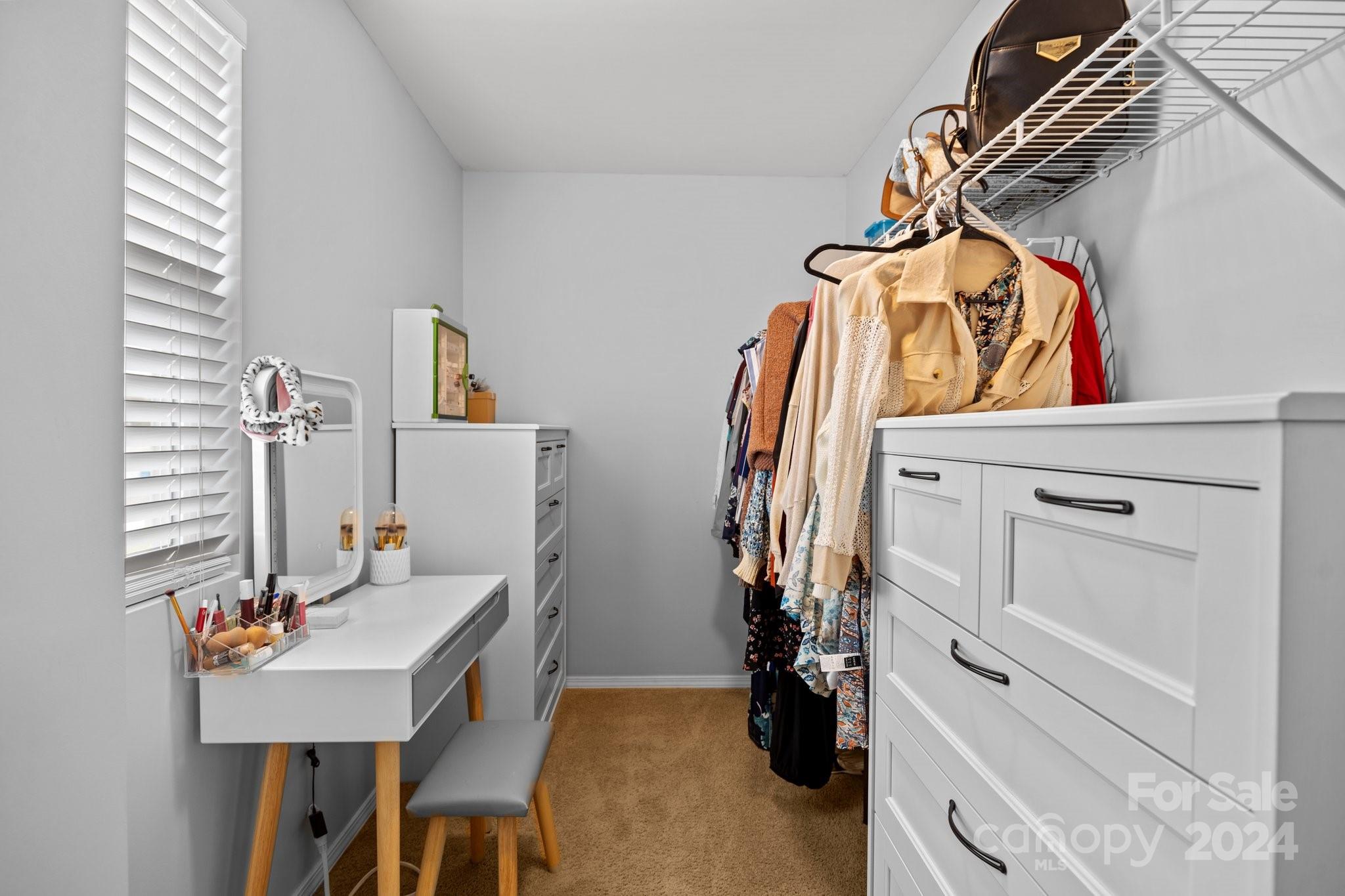 10231 Enniscrone Road Pineville, NC 28134 - Photo 30 of 44 a view of walk in closet with clothes and shoes